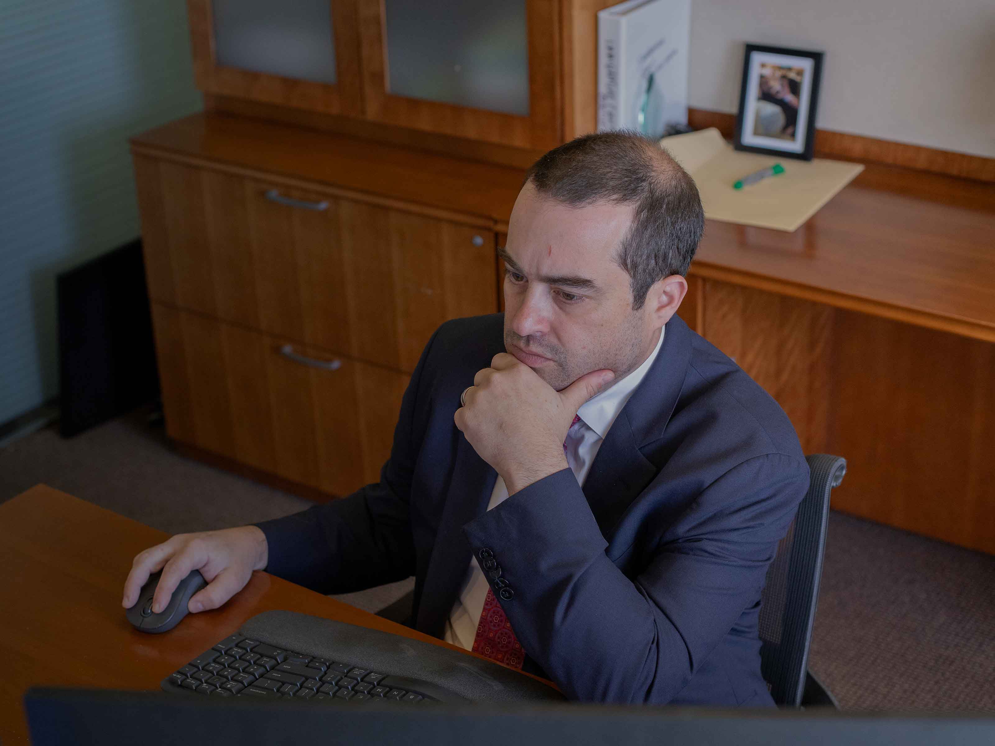 A BIRG Law attorney studying a case on his computer screen in his office