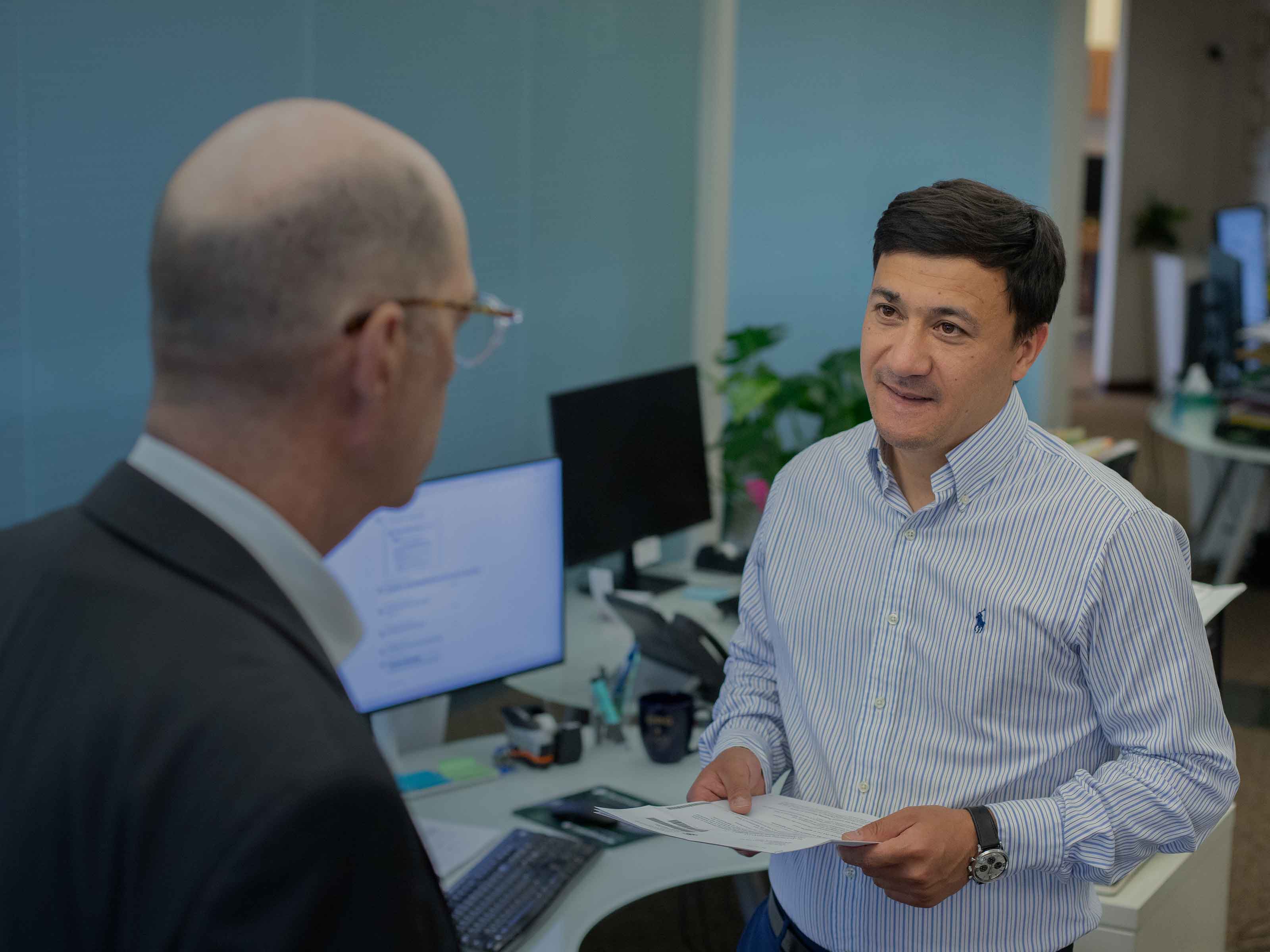 Two BIRG Law colleagues reviewing a document together in the open office